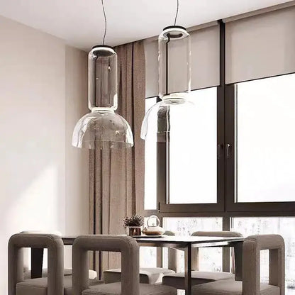 Two modern black glass led pendant lights with clear cylindrical and dome-shaped fixtures for dining room use