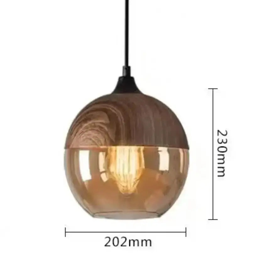 A modern black glass pendant light with an amber spherical shade and wood-grain texture for dining room decorbites black glass