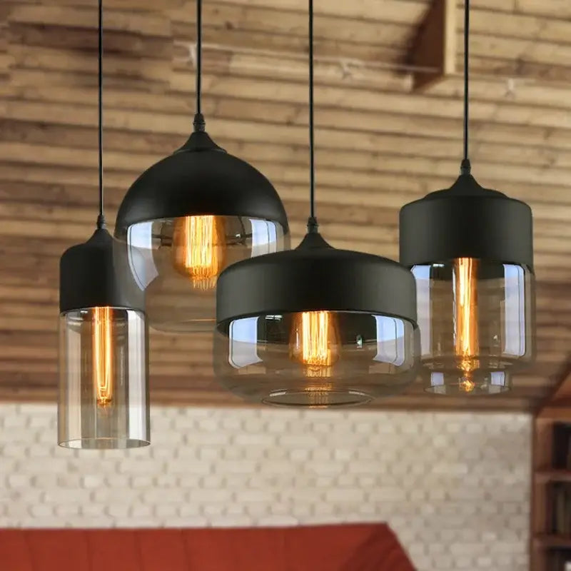 Set of four black glass pendant lights with clear shades and exposed bulbs for dining room decorbites black glass
