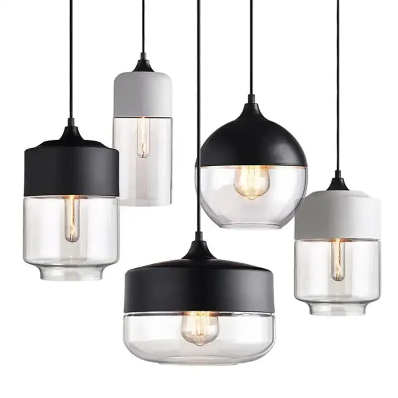 Modern black glass pendant light set with clear glass shades and exposed filament bulbs for dining room decorbites black glass