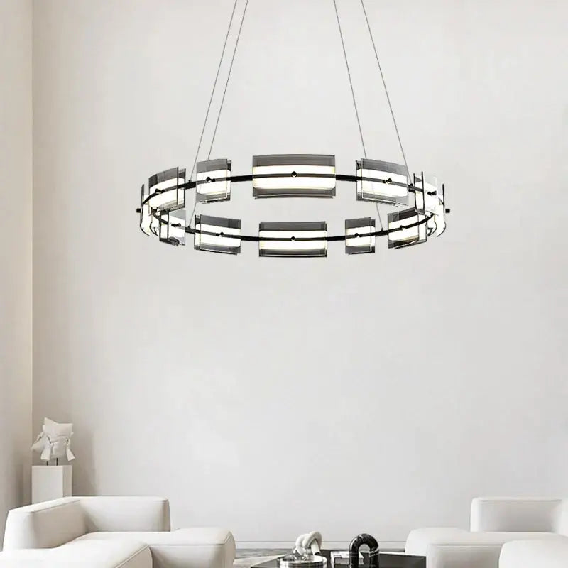 Modern black glass restaurant chandelier with circular metal frame and frosted glass panels for warm dining room lighting