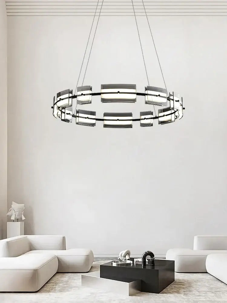 Modern black glass restaurant chandelier with circular metal frame and frosted panels for warm dining room light