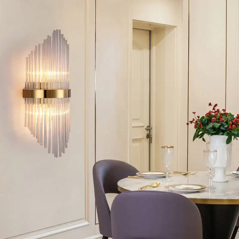 Modern black glass rod crystal wall lamp featuring vertical glass rods and a gold-toned metallic frame for bedroom use