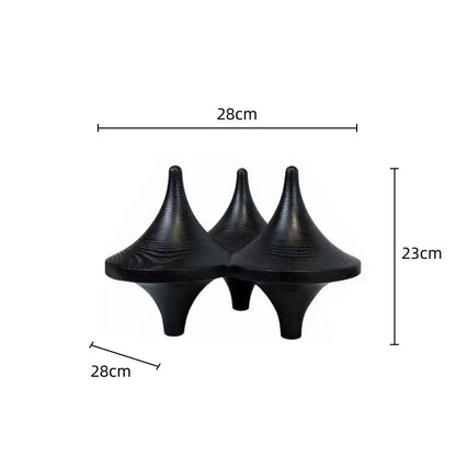 Three black glossy decorbites geometric gyroscope cone decor with textured surfaces for modern living room design