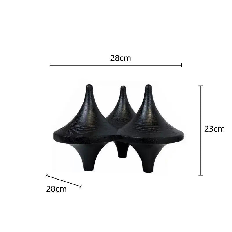 Three black glossy decorbites geometric gyroscope cone decor with textured surfaces for modern living room design