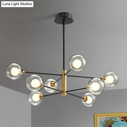 DecorBites modern black and gold 8-light chandelier offers clear glass globes on a brass rectangular frame with 32-inch fixture width