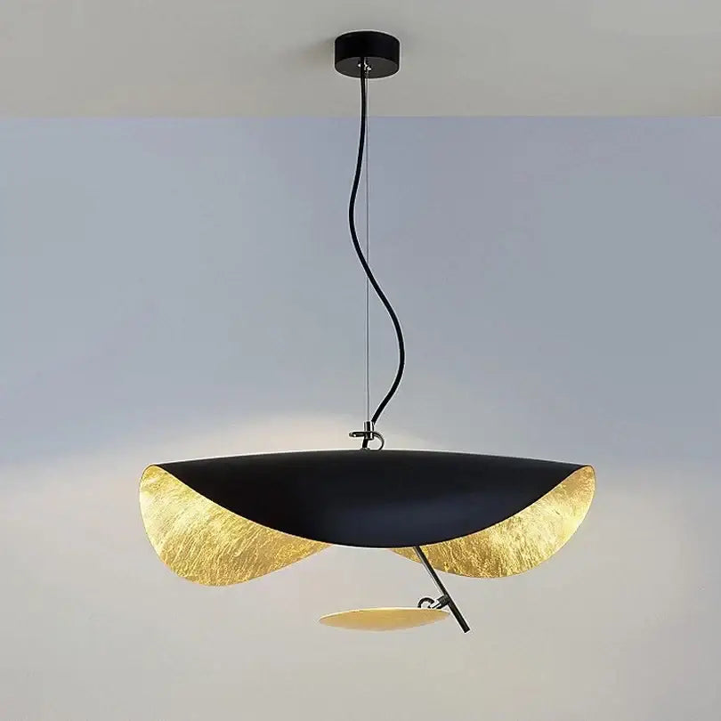 Modern black and gold leaf-shaped pendant lamp with sleek sculptural design ideal for dining room decorbites lederam manta