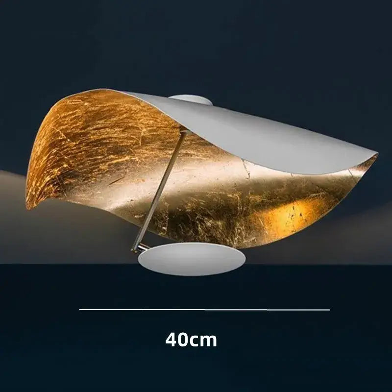 Modern black and gold abstract pendant lamp with curved design in textured gold leaf and white metal for dining decorbites lederam manta pendant