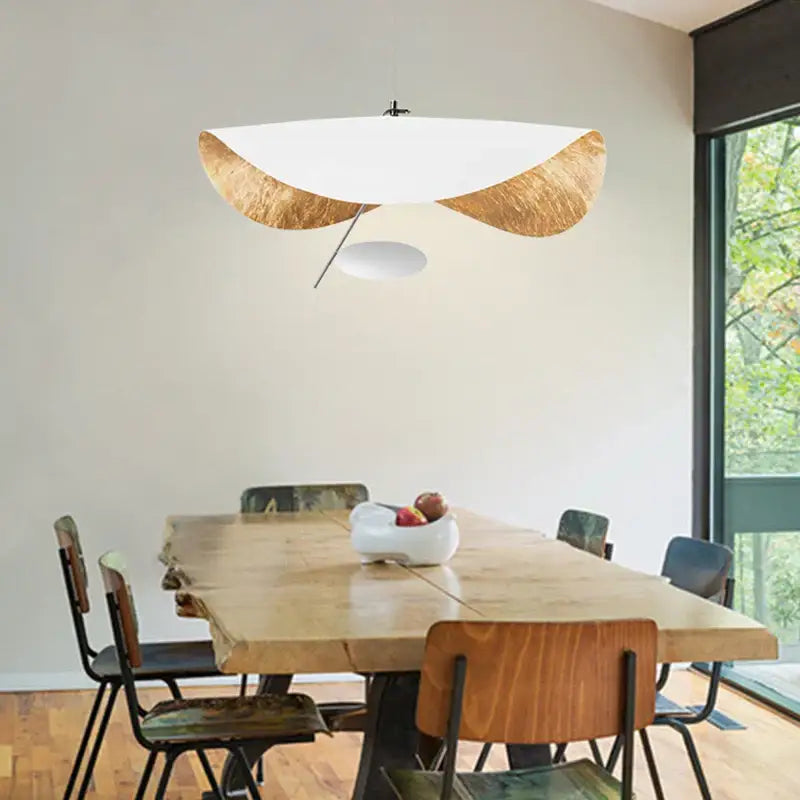 Modern pendant lamp with white curved glass shade and gold-leafed wooden accents for dining room decorbites lederam manta