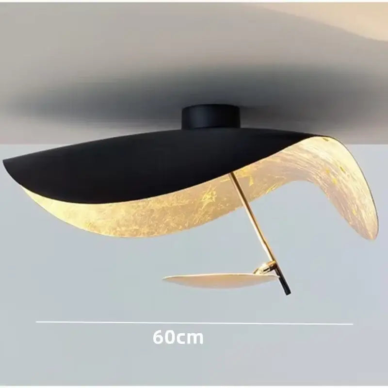 Modern black and gold abstract pendant light with sleek black shade and gold leaf finish by decorbites lederam manta