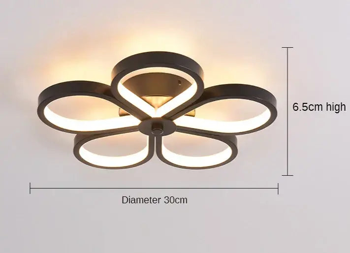 Modern black and gold acrylic flower twisted ceiling lamp with five illuminated rings and warm white lighting for living room