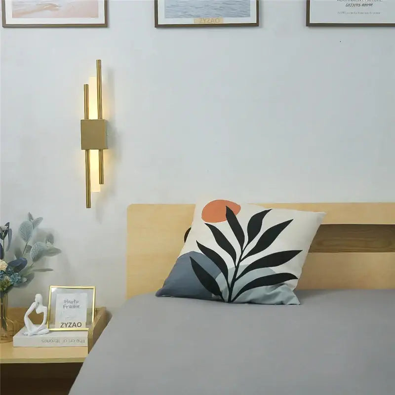 Modern black and gold acrylic pipe wall lamp featuring a gold-toned minimalist acrylic pipe wall sconce with vertical bars