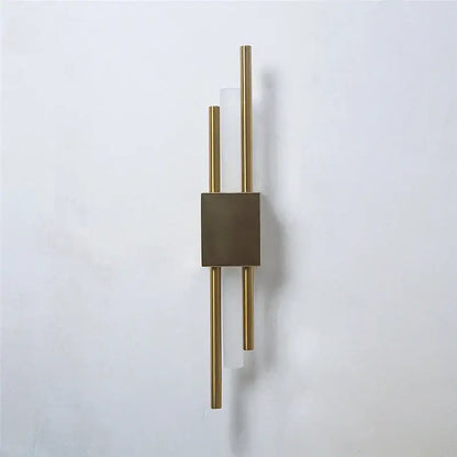 Modern black and gold acrylic pipe wall lamp with gold-toned sconce, matte bronze square, and frosted glass accents