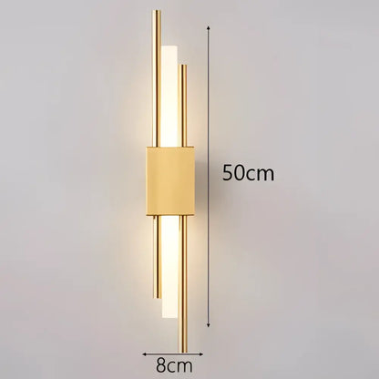 Modern black and gold acrylic pipe wall lamp featuring a gold-toned sconce with sleek vertical bars and warm light