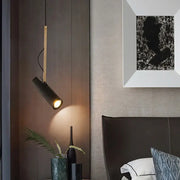 A modern black and gold decorbites adjustable led track light with a matte cylindrical head for kitchen island lighting