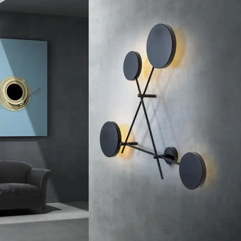 Modern black and gold decorbites adjustable rotating led wall sconce with geometric minimalist design and warm ambient light