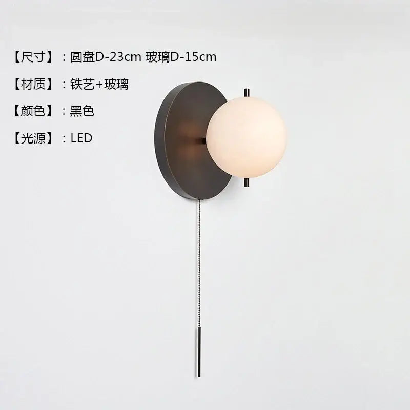 Modern black gold ball wall lamp featuring a black wrought iron and glass spherical sconce with led lighting decorbites black gold