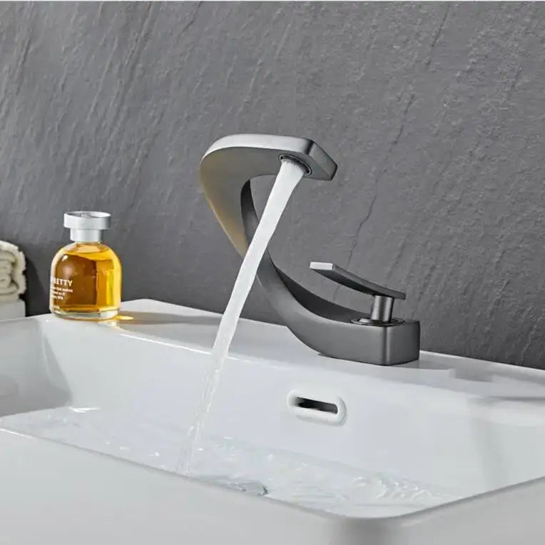 Modern black and gold basin faucet with a sleek matte black design and polished chrome accents by decorbites black