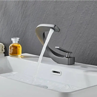 Modern black and gold basin faucet with a sleek matte black design and polished chrome accents by decorbites black