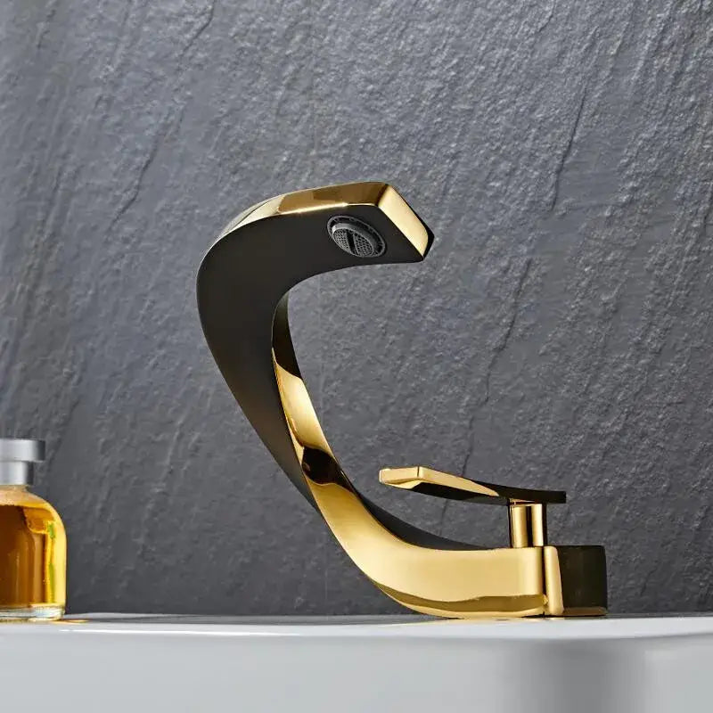 Modern black and gold basin faucet with sleek curved design and polished metallic finish by decorbites black
