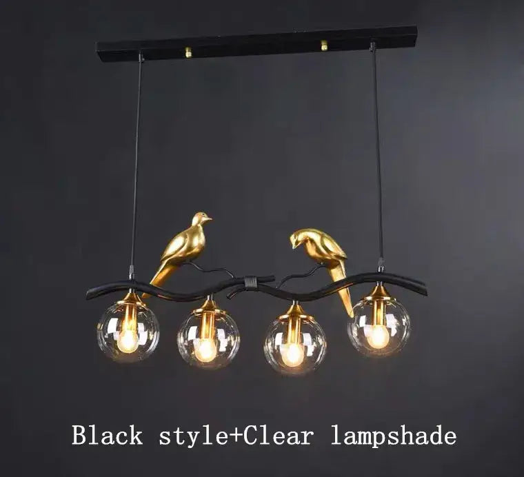 Modern black and gold bird glass pendant lights featuring clear globe lampshades for dining room lighting