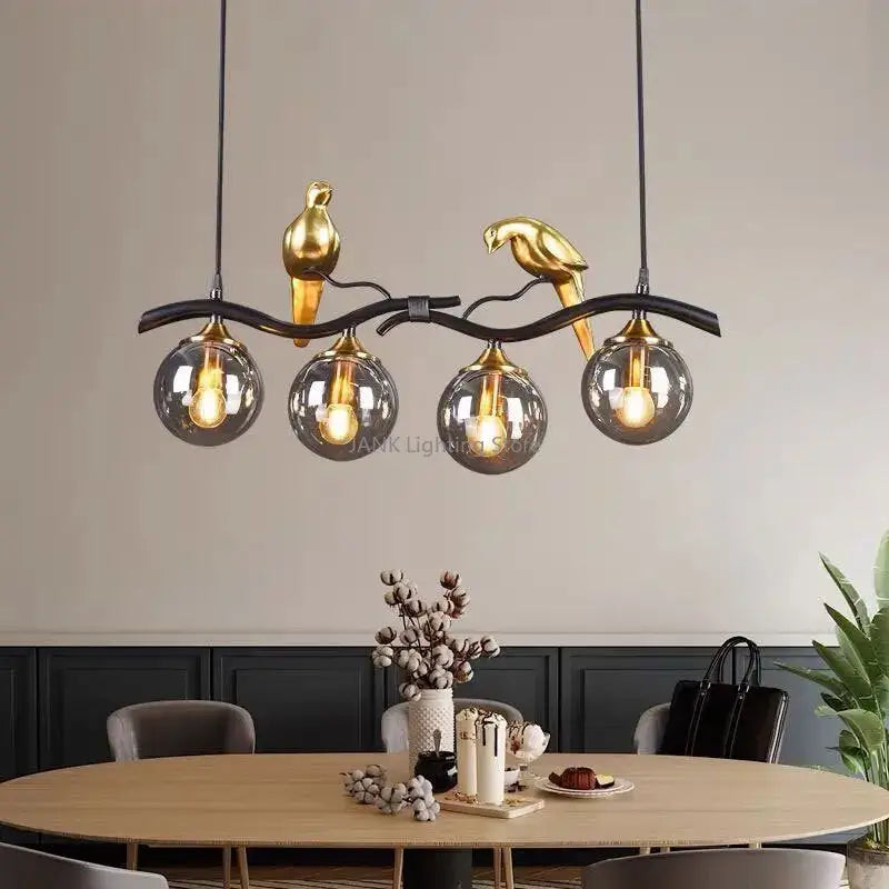 Modern black and gold bird glass pendant lights with black metal branch and four smoked glass globe shades for dining room