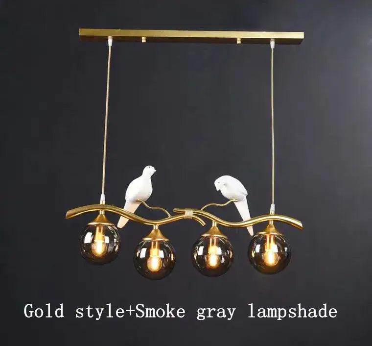 Modern black and gold glass pendant lights with smoked gray globes and white ceramic dove figurines for dining rooms