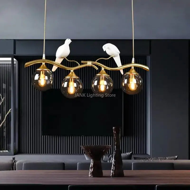 Modern black and gold bird glass pendant lights with amber glass globes and white ceramic bird figurines for dining room