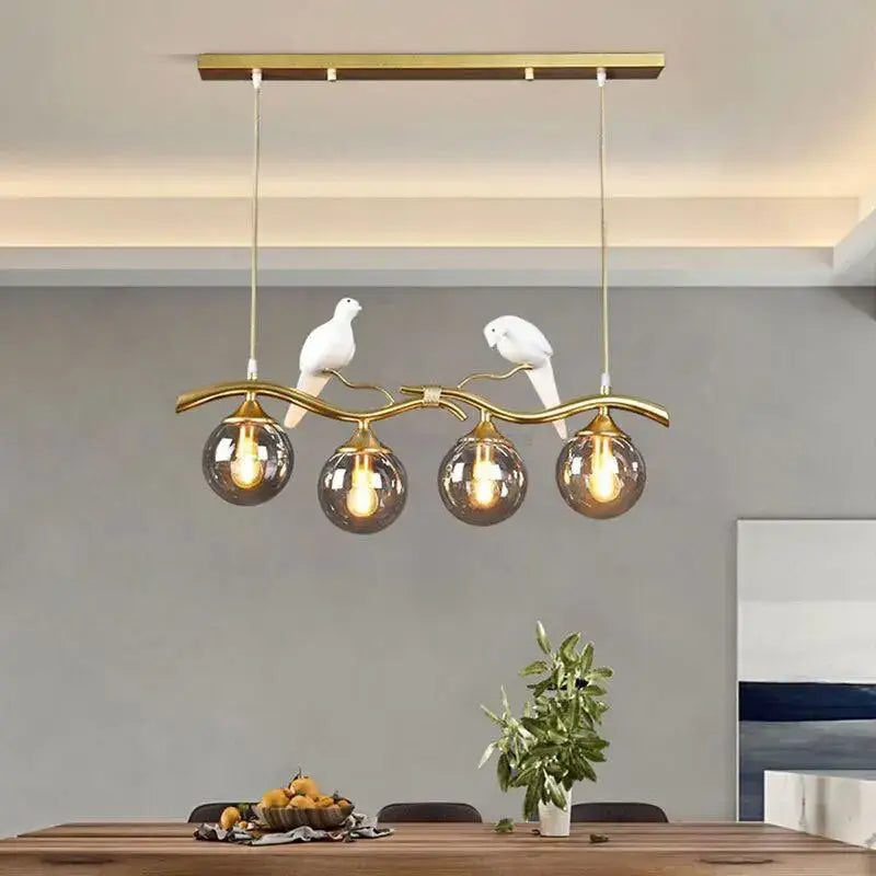 Modern black and gold glass pendant lights with smoked glass globes and white ceramic dove figurines for dining room