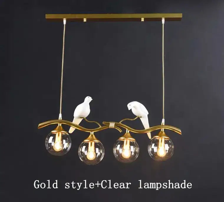 Modern black and gold glass pendant lights featuring a curved branch with two white ceramic birds for dining room use