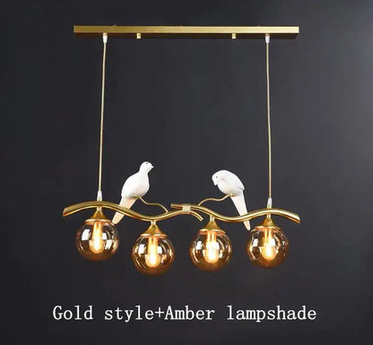 Modern black and gold glass pendant lights featuring gold-toned branch design with white ceramic doves and amber globes