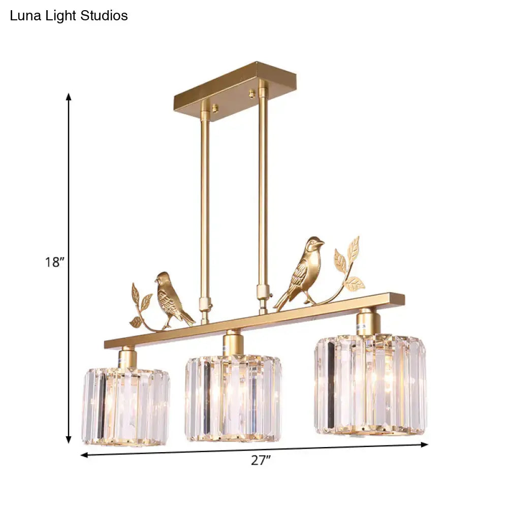 Gold-toned DecorBites™ modern black gold chandelier with three clear crystal drum shades and ornamental bird accents