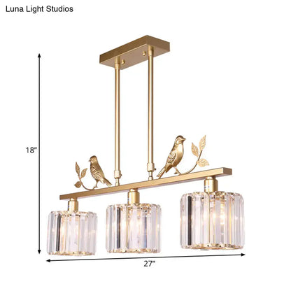 Gold-toned DecorBites™ modern black gold chandelier with three clear crystal drum shades and ornamental bird accents