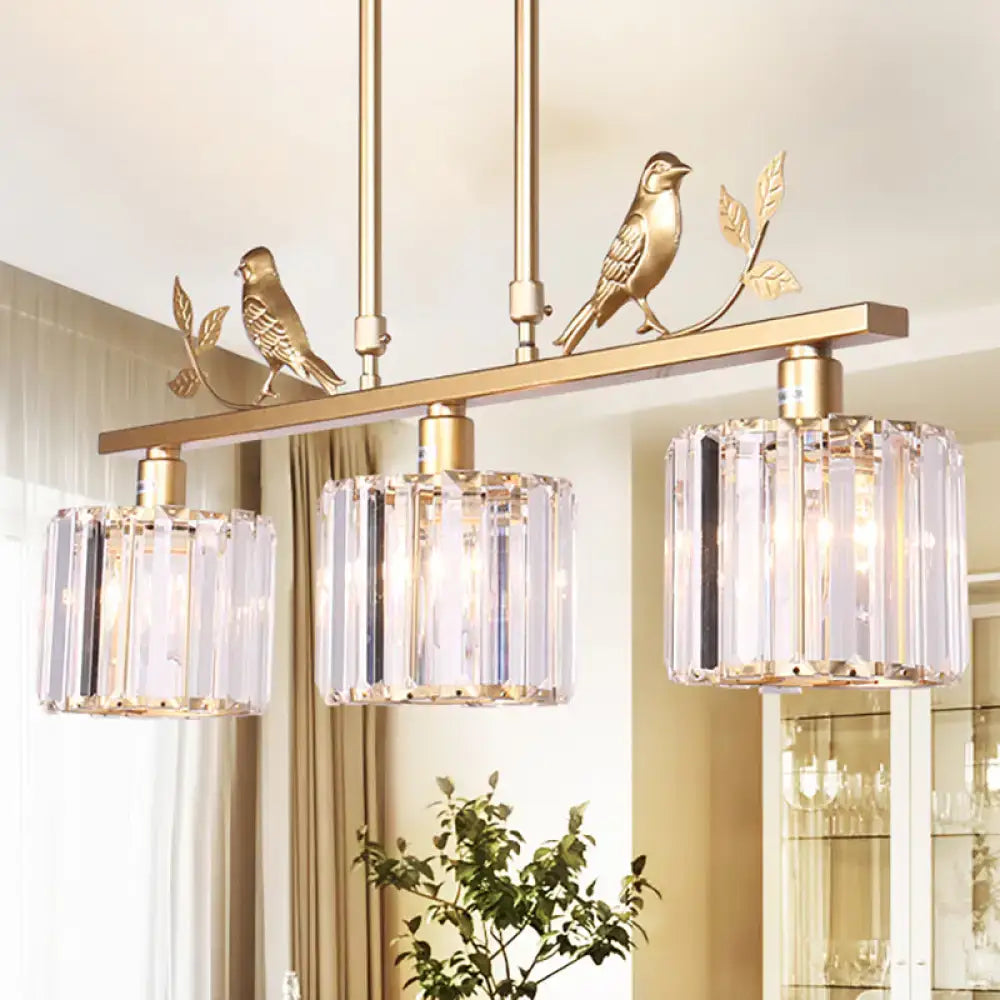 Gold-toned DecorBites modern chandelier with three clear crystal prism drum shades and black gold bird accents