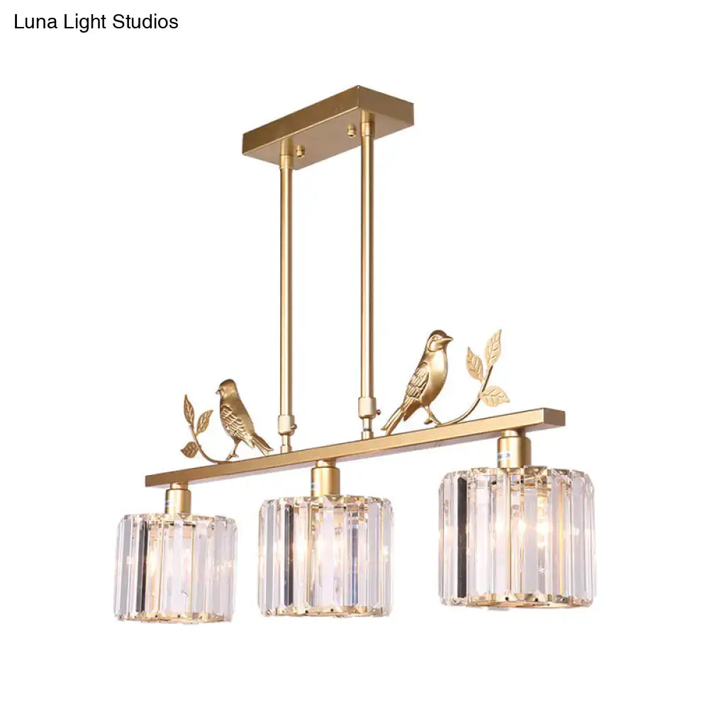 Gold-toned DecorBites™ chandelier with black gold finish, clear crystal drum shade, and ornamental bird accents on branches