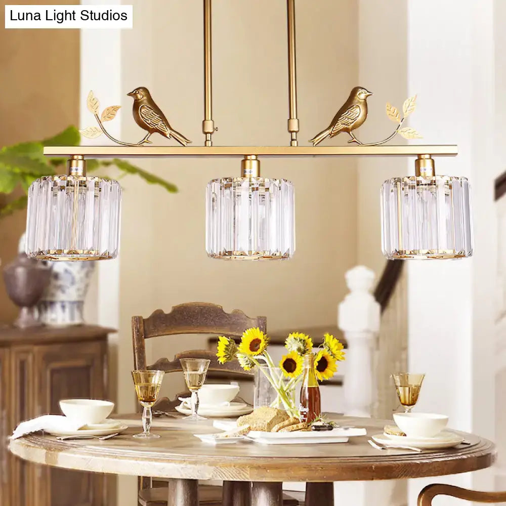 Gold-toned DecorBites modern black gold chandelier with three clear crystal drum shades and ornamental bird accents