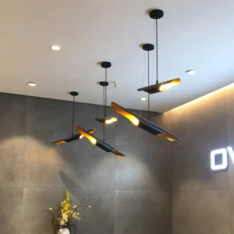 Modern black and gold decorbites coltrane pendant light with sleek wing-like blades for dining room pendant lighting