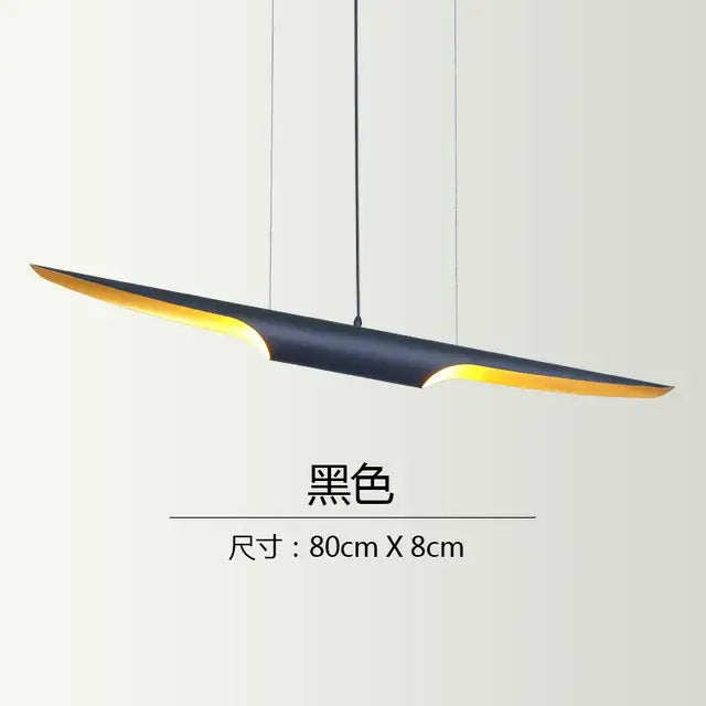 Modern black and gold blade pendant light with a sleek design and warm yellow interior for dining room decorbites coltrane pendant