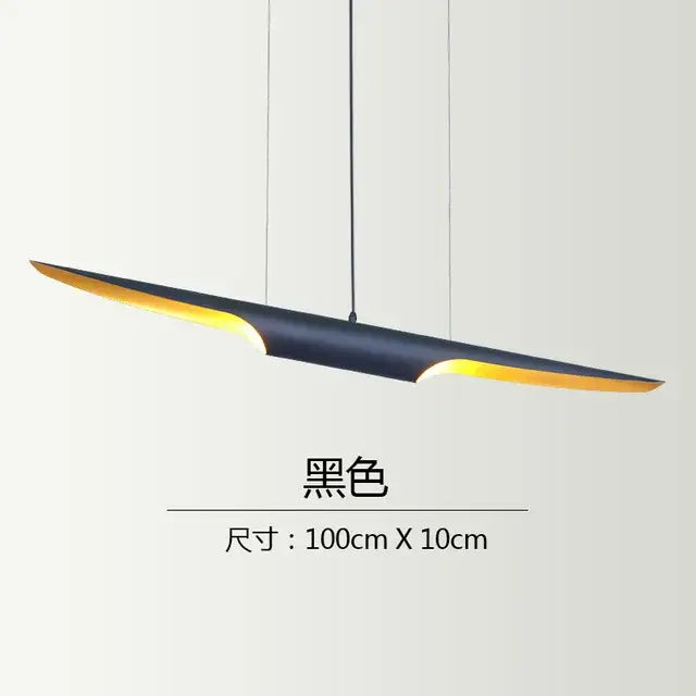 Modern black and gold blade pendant light with sleek elongated design and warm golden inner glow for dining room decorbites coltrane pendant light