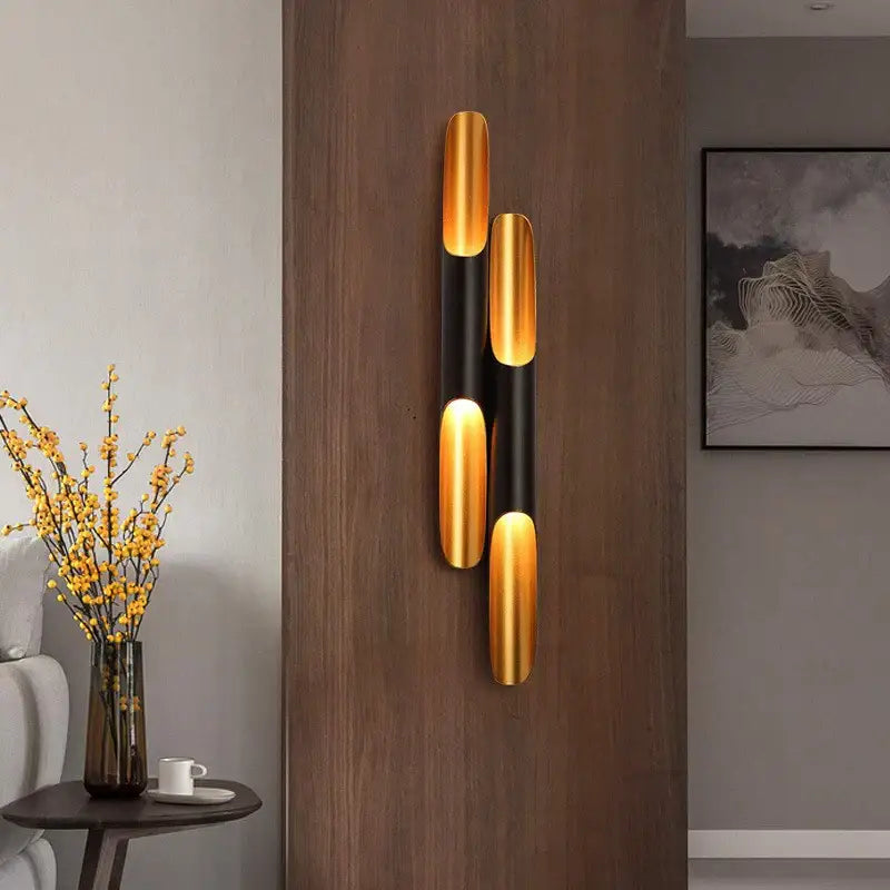 Modern black and gold pendant light with three vertical cylindrical elements for dining room decorbites coltrane pendant