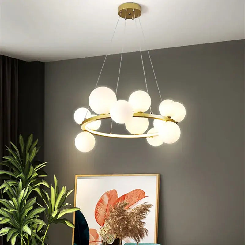 Modern black and gold branching bubbles chandelier with frosted glass spheres in gold-toned circular frame for dining room decorbites branching bubbles