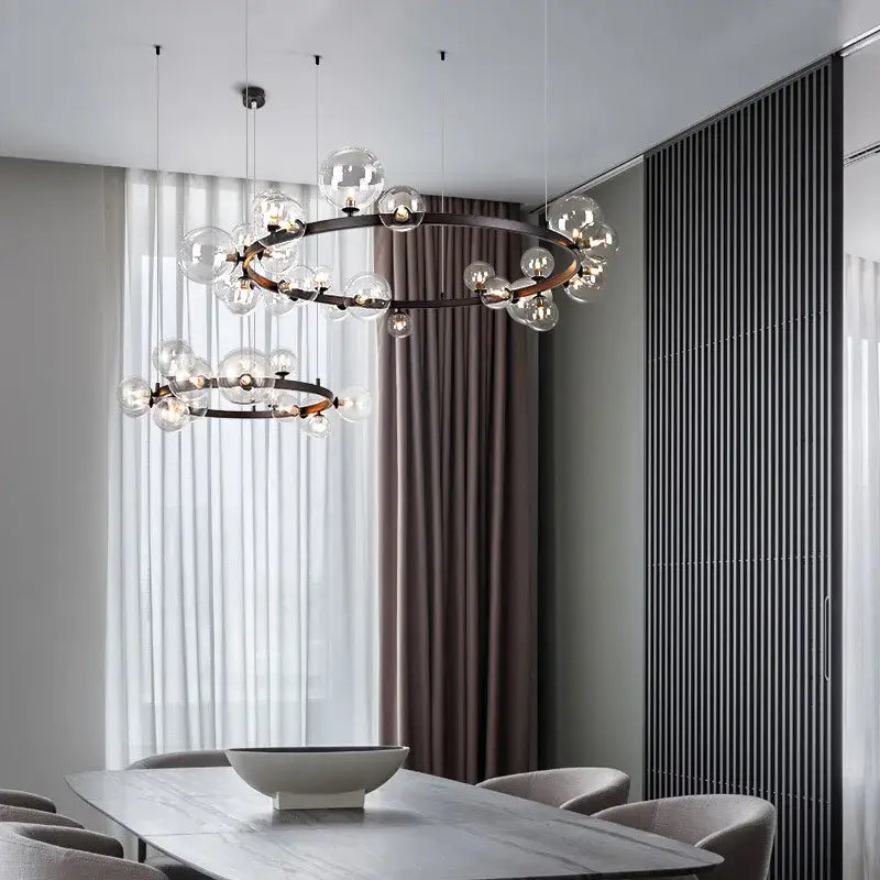 Modern black and gold branching bubbles chandelier with glass bubbles and dark metal frame for dining room decorbites