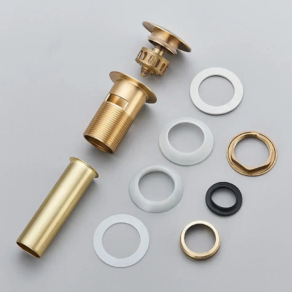 Modern black and gold brass basin sink pop up drain stopper showing gold-toned brass faucet assembly with gaskets decorbites brass basin