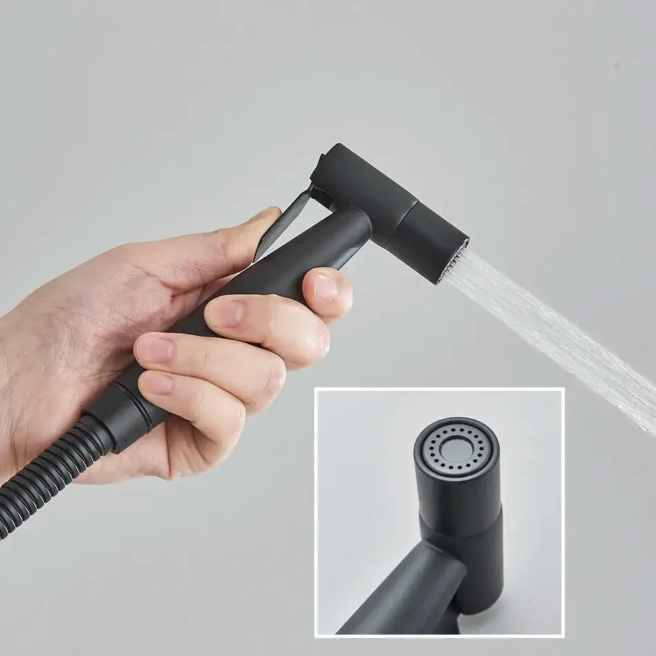 Modern black and gold brass bidet faucet handheld sprayer with matte finish flexible hose and adjustable nozzle for bathroom use
