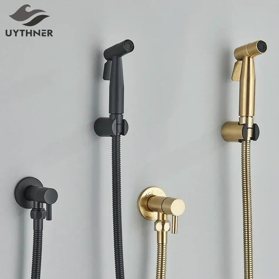 Modern black and gold brass bidet faucet with wall-mounted spray nozzles and flexible braided hoses for bathroom use