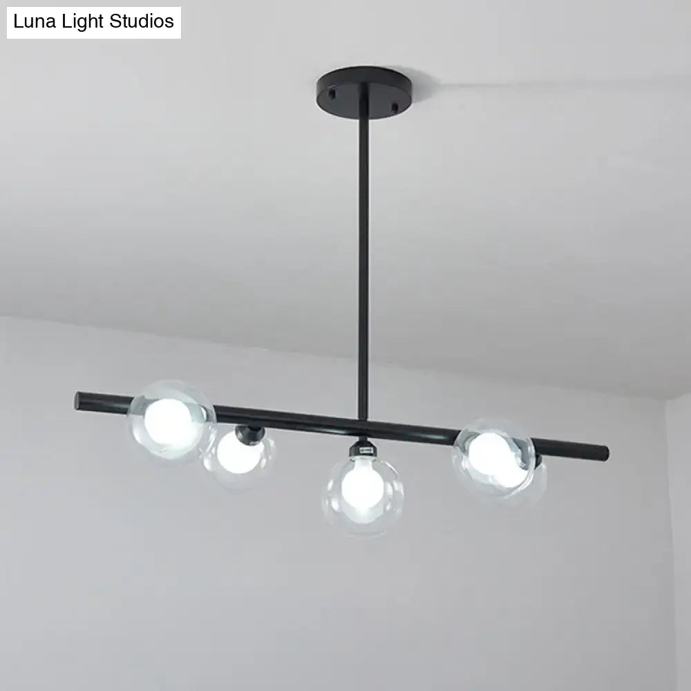 Modern black ceiling light with three bubble clear glass globes and sleek horizontal bar for clear glass island use