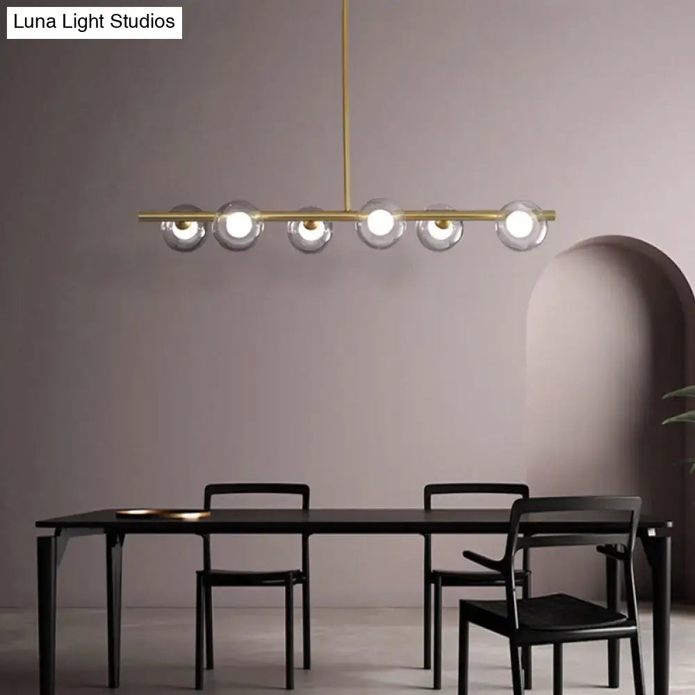 Modern black and gold ceiling light with five bubble clear glass globe shades for clear glass island dining room use