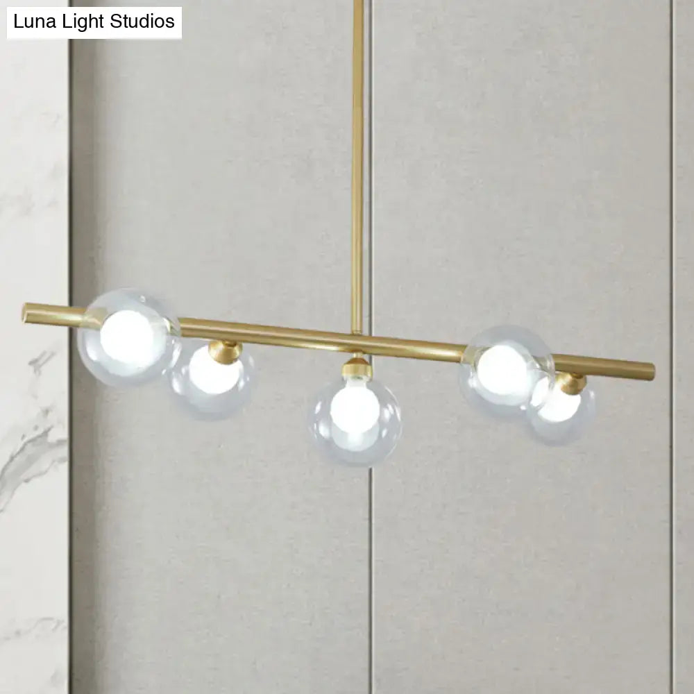 Modern black and gold ceiling light with brass fixtures and bubble clear glass bulbs for clear glass island dining room