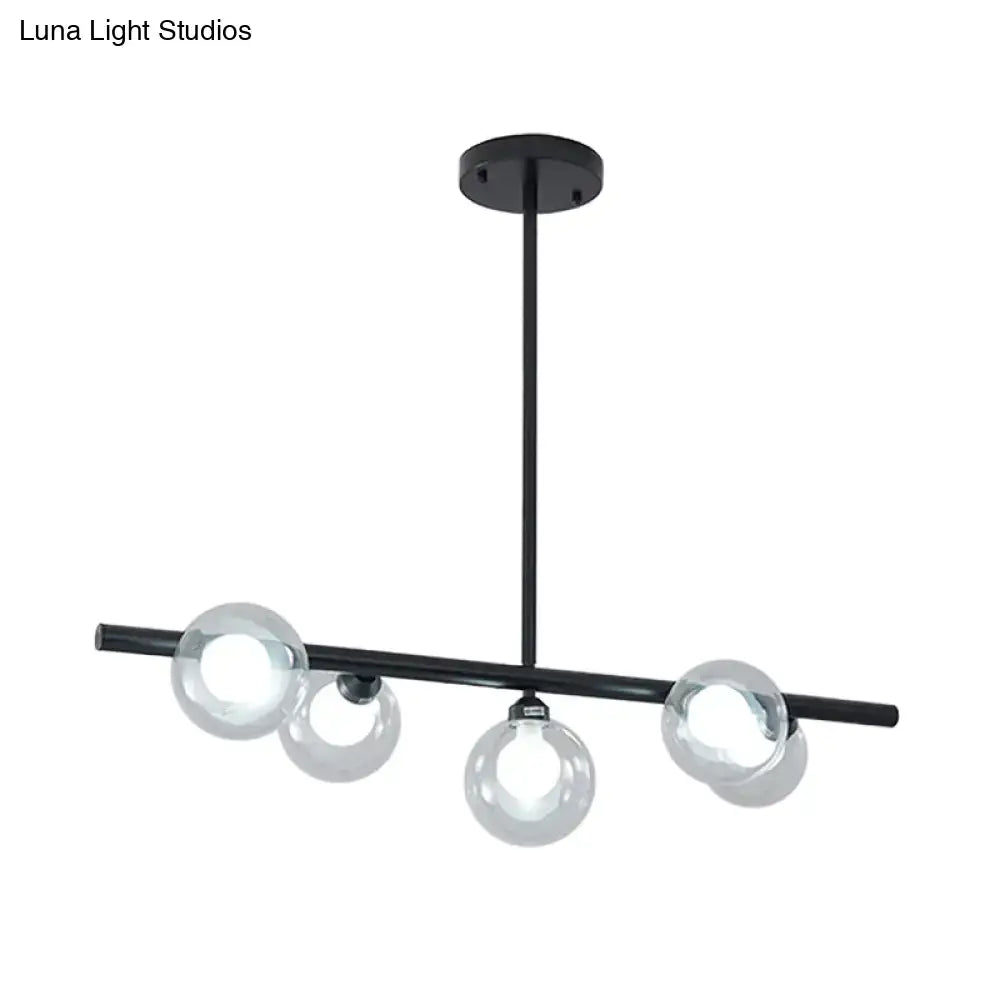 Modern black metal chandelier with gold accents featuring bubble clear glass globe bulbs for clear glass island lighting