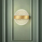 Modern black and gold circle led wall lamp with concentric glowing rings and polished gold bar ideal choice for living room